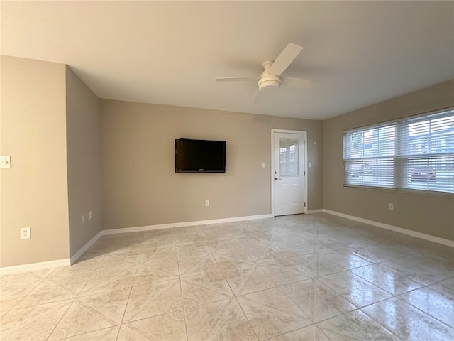 4158 Tamiami Trl Unit A5, Port Charlotte, FL 33952 - empty room featuring ceiling fan, light tile patterned flooring, and baseboards