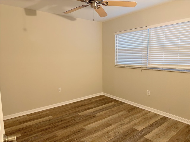 4158 Tamiami Trl Unit A5, Port Charlotte, FL 33952 - empty room featuring wood finished floors, a ceiling fan, and baseboards