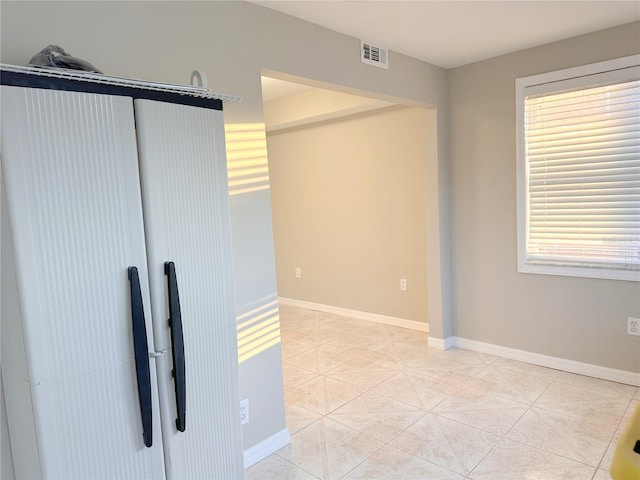 4158 Tamiami Trl Unit A5, Port Charlotte, FL 33952 - empty room featuring light tile patterned flooring and baseboards