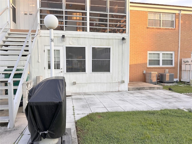 4158 Tamiami Trl Unit A5, Port Charlotte, FL 33952 - rear view of house featuring brick siding, central air condition unit, and a patio area