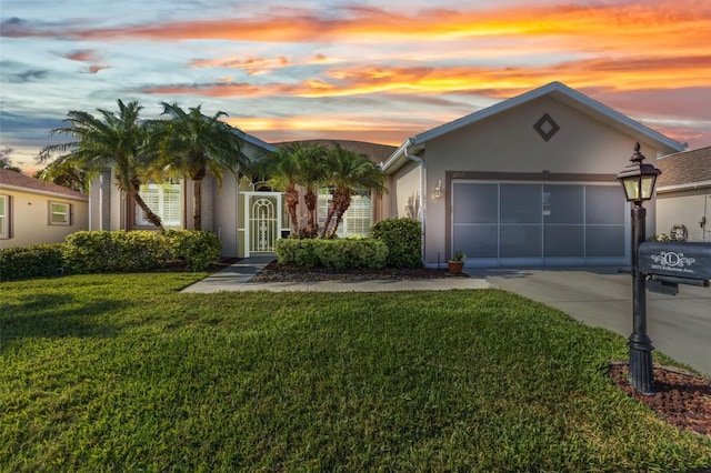 24371 Folkstone Ave, Punta Gorda, FL 33980 - view of front facade featuring stucco siding, concrete driveway, a garage, and a front yard