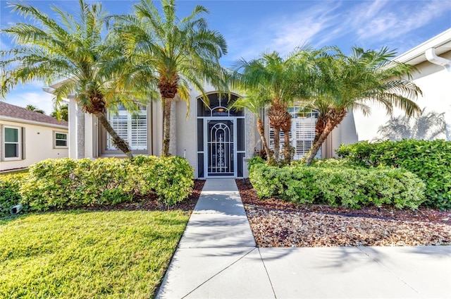 24371 Folkstone Ave, Punta Gorda, FL 33980 - property entrance featuring stucco siding