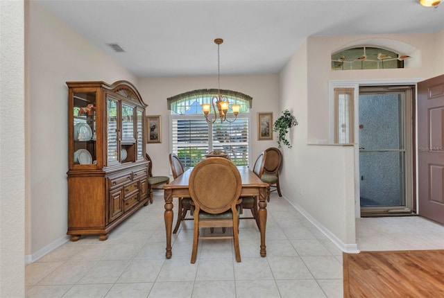 24371 Folkstone Ave, Punta Gorda, FL 33980 - dining space with a chandelier, baseboards, and light tile patterned flooring