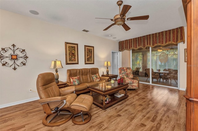 24371 Folkstone Ave, Punta Gorda, FL 33980 - living area featuring wood finished floors, baseboards, and a ceiling fan