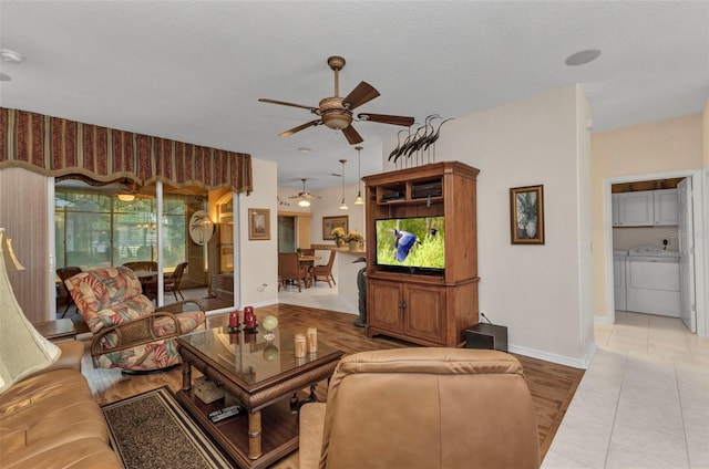 24371 Folkstone Ave, Punta Gorda, FL 33980 - tiled living room with a ceiling fan, washing machine and clothes dryer, and baseboards