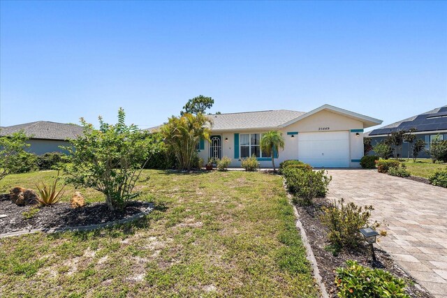 25449 Doredo Dr, Punta Gorda, FL 33955 - ranch-style house featuring an attached garage, decorative driveway, a front yard, and stucco siding