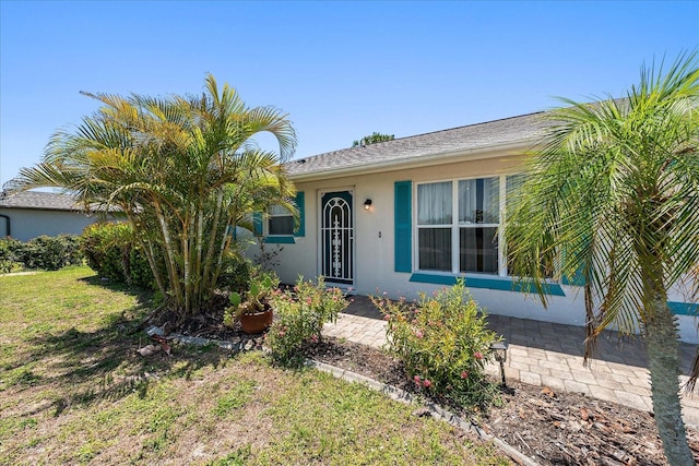 25449 Doredo Dr, Punta Gorda, FL 33955 - view of front of property featuring stucco siding and a front yard