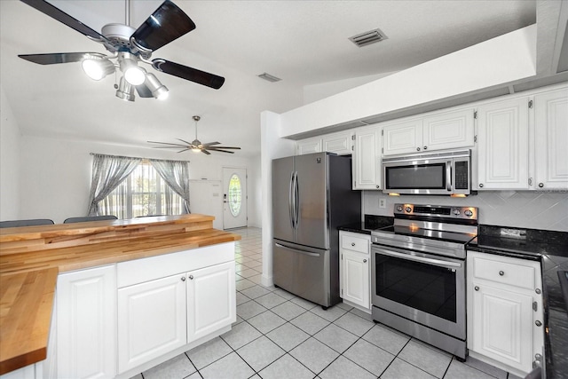 25449 Doredo Dr, Punta Gorda, FL 33955 - kitchen featuring appliances with stainless steel finishes, butcher block countertops, lofted ceiling, ceiling fan, and white cabinets