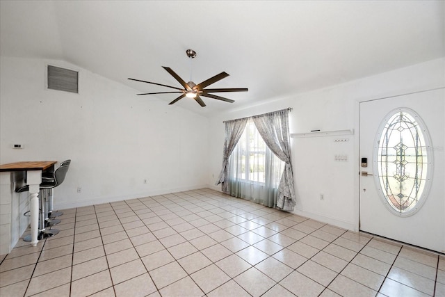 25449 Doredo Dr, Punta Gorda, FL 33955 - entryway featuring vaulted ceiling, a ceiling fan, light tile patterned floors, and baseboards