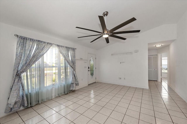 25449 Doredo Dr, Punta Gorda, FL 33955 - empty room with lofted ceiling, ceiling fan, light tile patterned floors, and baseboards