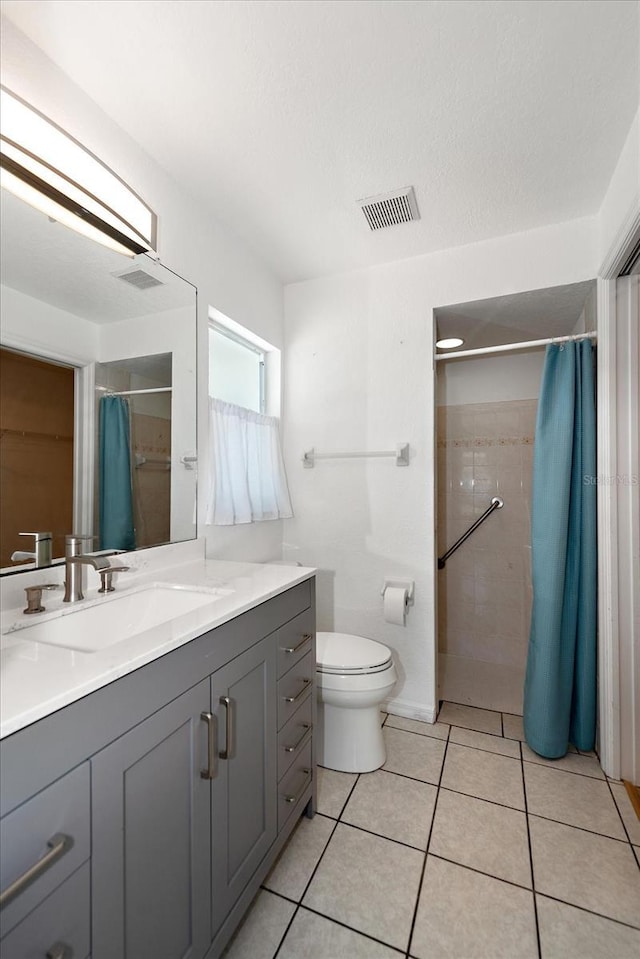 25449 Doredo Dr, Punta Gorda, FL 33955 - full bath with tiled shower, vanity, toilet, and tile patterned flooring