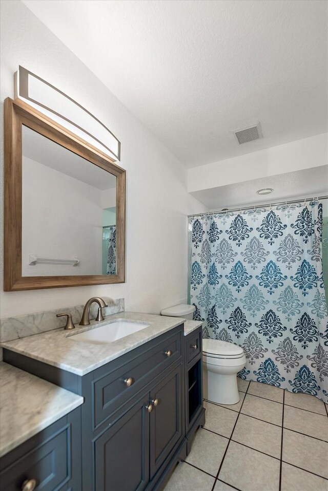 25449 Doredo Dr, Punta Gorda, FL 33955 - full bath with toilet, vanity, tile patterned floors, and a shower with curtain