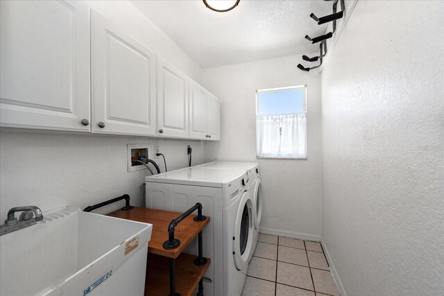 25449 Doredo Dr, Punta Gorda, FL 33955 - laundry room with cabinet space, independent washer and dryer, baseboards, and light tile patterned floors