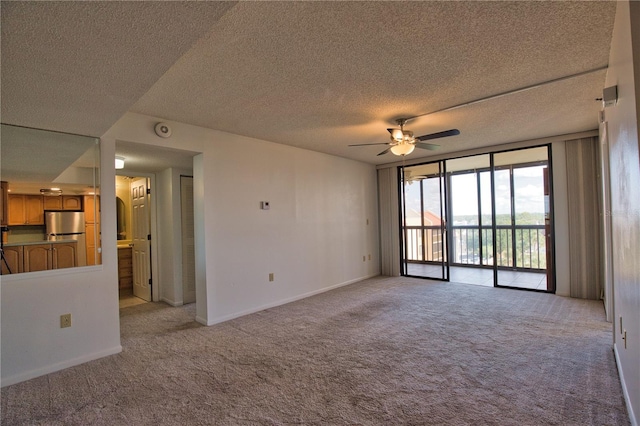 3006 Caring Way Unit 615, Port Charlotte, FL 33952 - empty room with light carpet, ceiling fan, a textured ceiling, a smoke detector, and baseboards
