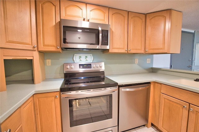 3006 Caring Way Unit 615, Port Charlotte, FL 33952 - kitchen with stainless steel appliances, light countertops, a sink, and light brown cabinets