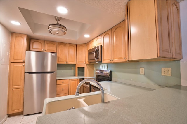 3006 Caring Way Unit 615, Port Charlotte, FL 33952 - kitchen with appliances with stainless steel finishes, recessed lighting, a tray ceiling, a sink, and light countertops