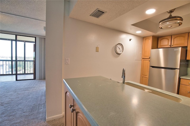 3006 Caring Way Unit 615, Port Charlotte, FL 33952 - kitchen featuring freestanding refrigerator, carpet, a textured ceiling, floor to ceiling windows, and recessed lighting
