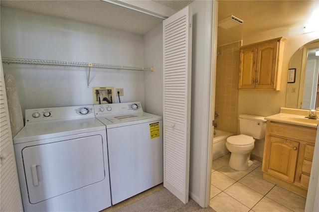 3006 Caring Way Unit 615, Port Charlotte, FL 33952 - laundry area with arched walkways, independent washer and dryer, and light tile patterned floors