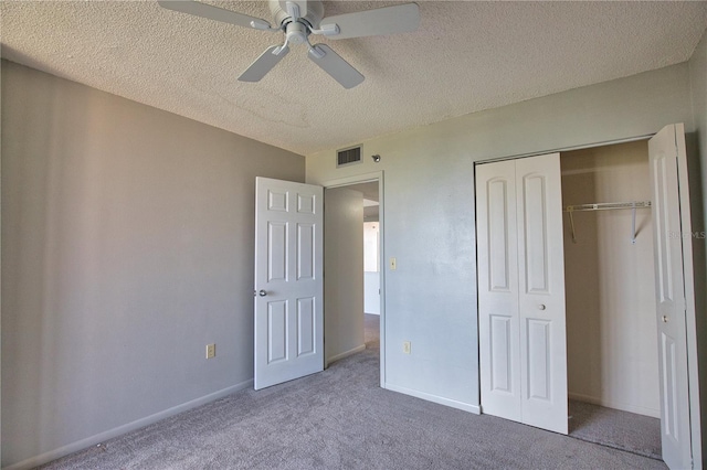 3006 Caring Way Unit 615, Port Charlotte, FL 33952 - unfurnished bedroom featuring carpet flooring, a textured ceiling, a closet, a ceiling fan, and baseboards
