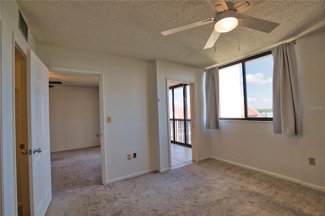 3006 Caring Way Unit 615, Port Charlotte, FL 33952 - carpeted empty room featuring a ceiling fan, a textured ceiling, and baseboards
