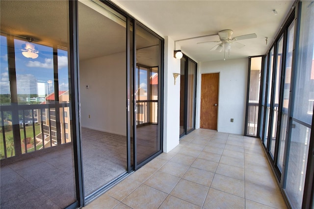 3006 Caring Way Unit 615, Port Charlotte, FL 33952 - unfurnished sunroom featuring floor to ceiling windows, a ceiling fan, and tile patterned floors
