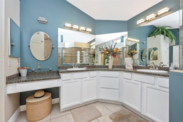 full bathroom featuring tile patterned floors, a walk in shower, and double vanity