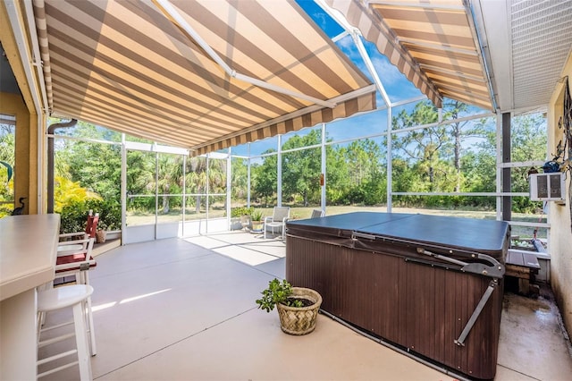view of patio / terrace with a hot tub, view of wooded area, a lanai, and a grill