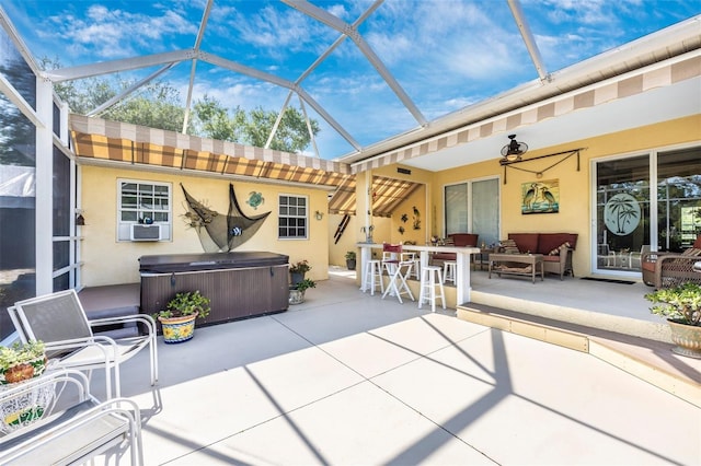 view of patio featuring a hot tub, an outdoor hangout area, glass enclosure, and cooling unit