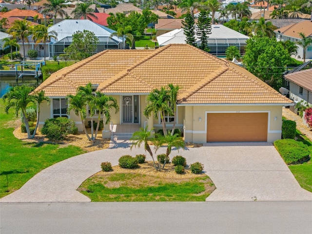 2719 Mayaguana Ct, Punta Gorda, FL 33950 - mediterranean / spanish-style house with a tile roof, stucco siding, driveway, an attached garage, and a residential view