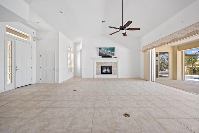 2719 Mayaguana Ct, Punta Gorda, FL 33950 - unfurnished living room with a ceiling fan, a fireplace, tile patterned floors, and high vaulted ceiling