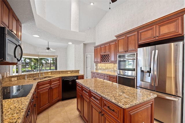 2719 Mayaguana Ct, Punta Gorda, FL 33950 - kitchen featuring black appliances, ceiling fan, a sink, light stone countertops, and high vaulted ceiling
