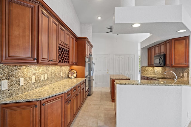 2719 Mayaguana Ct, Punta Gorda, FL 33950 - kitchen featuring black microwave, light stone countertops, tasteful backsplash, light tile patterned floors, and recessed lighting