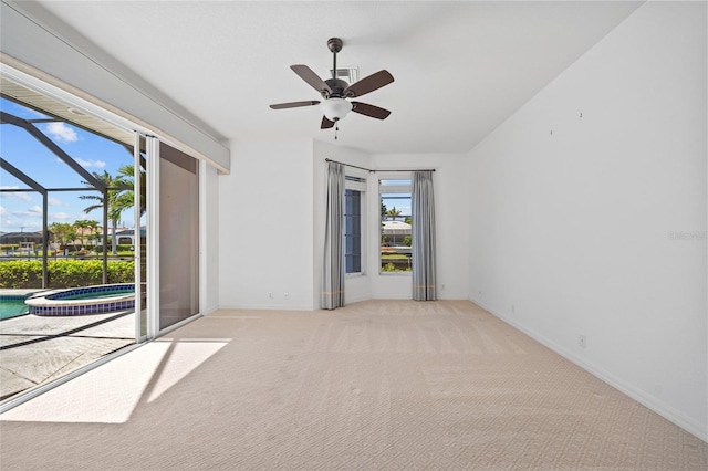 2719 Mayaguana Ct, Punta Gorda, FL 33950 - spare room featuring a ceiling fan, carpet, baseboards, and a sunroom