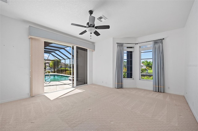 2719 Mayaguana Ct, Punta Gorda, FL 33950 - carpeted spare room featuring a ceiling fan, a sunroom, and baseboards