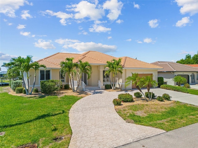 2719 Mayaguana Ct, Punta Gorda, FL 33950 - mediterranean / spanish home with curved driveway, stucco siding, a garage, and a tiled roof