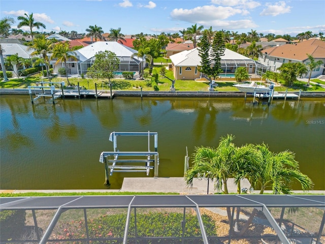 2719 Mayaguana Ct, Punta Gorda, FL 33950 - dock with a residential view, a water view, boat lift, and a lanai