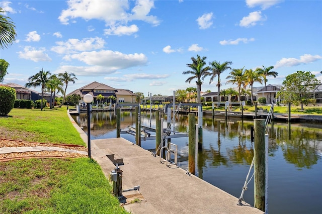 2719 Mayaguana Ct, Punta Gorda, FL 33950 - dock featuring boat lift, a water view, a residential view, and a lawn