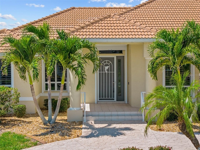 2719 Mayaguana Ct, Punta Gorda, FL 33950 - entrance to property with stucco siding and a tiled roof
