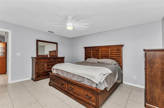 bedroom featuring light tile patterned flooring, baseboards, and a ceiling fan