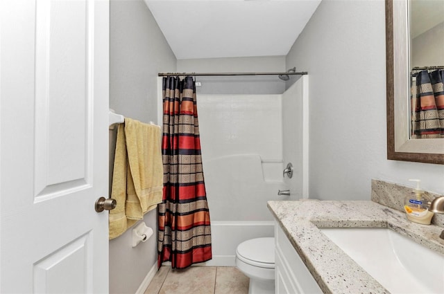 full bath with tile patterned floors, toilet, vanity, baseboards, and shower / bath combo