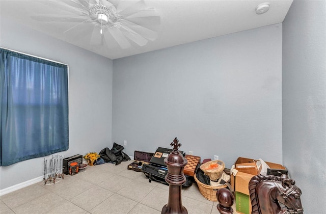 tiled spare room with a smoke detector, ceiling fan, and baseboards