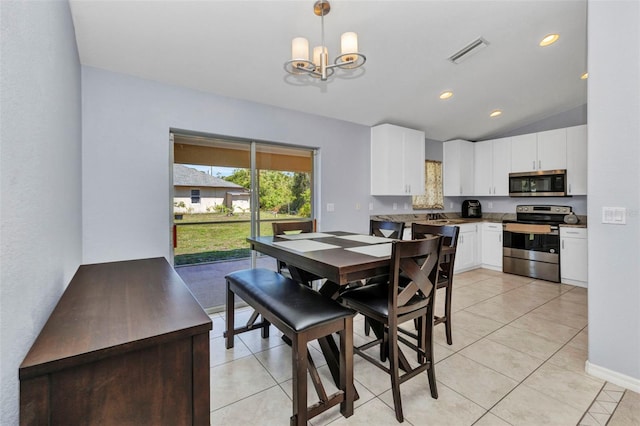 dining space featuring a chandelier, vaulted ceiling, light tile patterned floors, baseboards, and recessed lighting