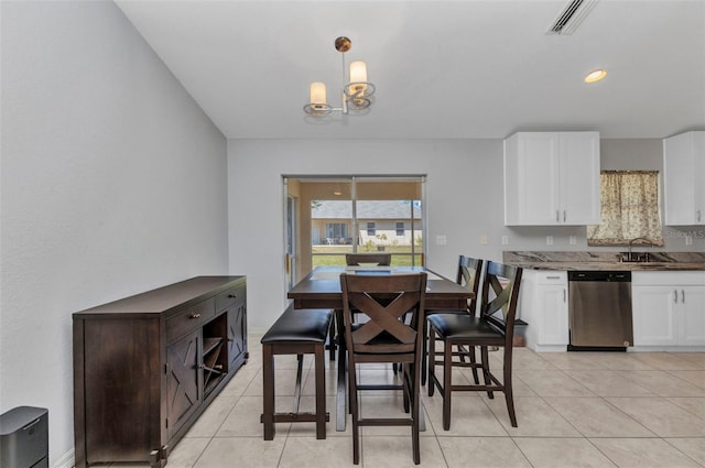 dining space featuring a chandelier and light tile patterned floors
