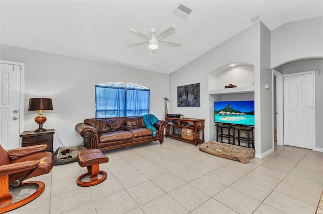 living room featuring vaulted ceiling, built in features, a ceiling fan, light tile patterned flooring, and baseboards