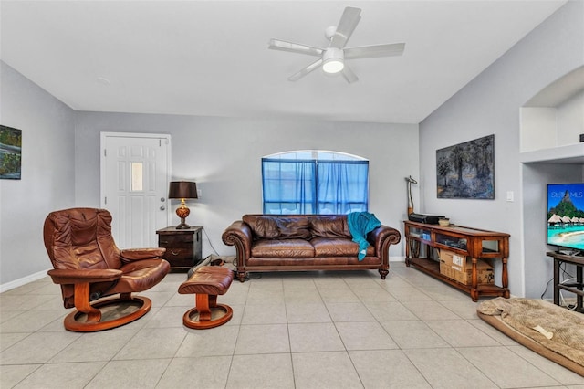 living room featuring a ceiling fan, baseboards, and light tile patterned floors