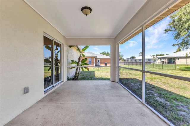 unfurnished sunroom with a residential view