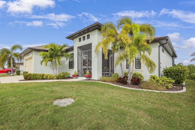 19246 Moore Haven Ct, Port Charlotte, FL 33948 - view of front of home featuring stucco siding, an attached garage, a front yard, and driveway