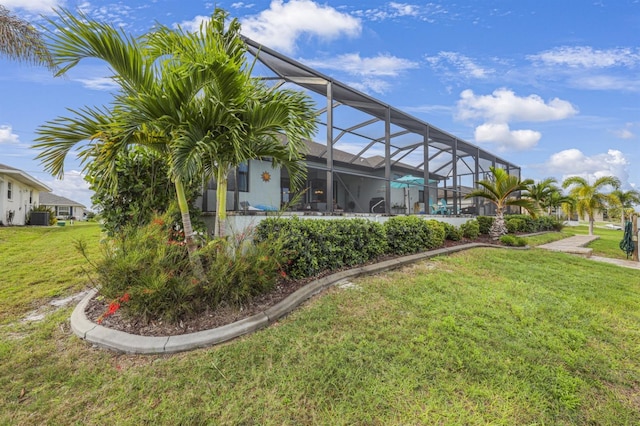 19246 Moore Haven Ct, Port Charlotte, FL 33948 - view of grassy yard with glass enclosure and central AC