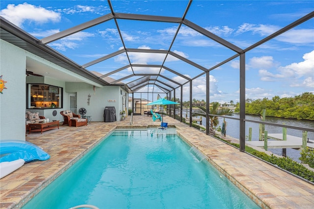 19246 Moore Haven Ct, Port Charlotte, FL 33948 - outdoor pool with a patio, a water view, ceiling fan, an outdoor living space, and glass enclosure