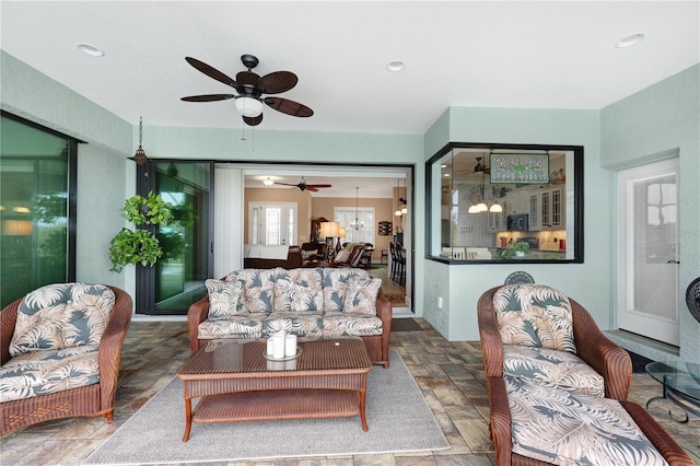 19246 Moore Haven Ct, Port Charlotte, FL 33948 - living area with stone tile floors and a ceiling fan